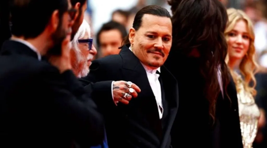 Johnny Depp's film 'Jeanne Du Barry' opened the 76th Cannes Film Festival with a remarkable seven-minute standing ovation. The actor, who plays King Louis XV in the movie, was visibly emotional as the crowd erupted in applause. This marks Depp's acting comeback after a three-year hiatus and a legal battle with ex-wife Amber Heard. Read on to watch the touching moment and learn more about the film's premiere at Cannes.