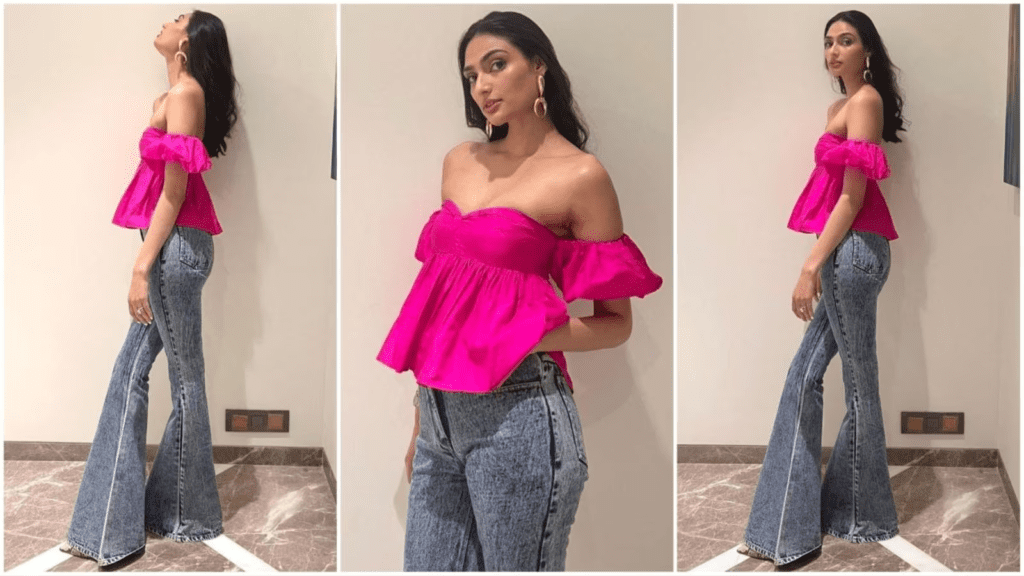 Athiya Shetty, known for her impeccable fashion sense, dazzles in a pink off-shoulder top matched with dark grey denims. Celebrity stylist Ami Patel's Instagram shares reveal Athiya's urban-chic ensemble, complemented by minimalist makeup and trendy accessories. Discover how Athiya effortlessly transforms basic pieces into a stylish statement, embodying her innate style and elegance.